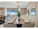 A long dining table for twelve is perfectly set, with bright natural light coming from large sliding glass doors at 2176 Lelani Cir, Davenport, FL 33897