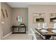 Neutral toned foyer with decorated console table and view through to dining room at 2176 Lelani Cir, Davenport, FL 33897