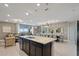 Open concept floor plan with a large kitchen island and view of dining room and living room at 2176 Lelani Cir, Davenport, FL 33897