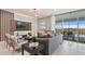 Stylish living room with a comfortable sofa, contemporary decor, and sliding glass doors leading to an outdoor patio at 2176 Lelani Cir, Davenport, FL 33897