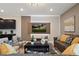 Comfortable living room with stylish seating, a large TV, and a view into the modern kitchen at 2176 Lelani Cir, Davenport, FL 33897