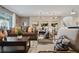 Spacious living room featuring modern decor, stylish furniture, and an open floor plan that flows into the dining area at 2176 Lelani Cir, Davenport, FL 33897
