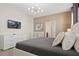 Comfortable main bedroom with modern gray decor, neutral walls, and entertainment center at 2176 Lelani Cir, Davenport, FL 33897