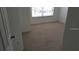 Bedroom featuring neutral carpet, a window for natural light, and closet space at 2219 San Vittorino Cir # 106, Kissimmee, FL 34741