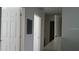 Hallway featuring white doors, neutral paint, and access to other areas of the home at 2219 San Vittorino Cir # 106, Kissimmee, FL 34741