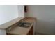Convenient wet bar featuring a sink, countertop, and wooden cabinetry in neutral tones at 2219 San Vittorino Cir # 106, Kissimmee, FL 34741