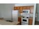 Functional kitchen with appliances including a white refrigerator, microwave, and stove at 2219 San Vittorino Cir # 106, Kissimmee, FL 34741
