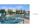 Community swimming pool with lounge chairs on deck, perfect for relaxation and recreation for residents at 2219 San Vittorino Cir # 106, Kissimmee, FL 34741