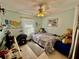 Comfortable bedroom with desk, plush seating, soft natural light, and tile floors at 2266 Lake Lizzie Ct, St Cloud, FL 34771