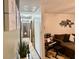 Hallway leading into living room with view of sectional sofa and decor at 2266 Lake Lizzie Ct, St Cloud, FL 34771