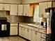 This kitchen has light cabinets, tile backsplash and modern appliances at 2266 Lake Lizzie Ct, St Cloud, FL 34771