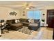 Cozy living room features a large sectional couch, tile floors, and a ceiling fan at 2266 Lake Lizzie Ct, St Cloud, FL 34771