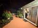 Covered patio area just outside the home with lots of plants at 2266 Lake Lizzie Ct, St Cloud, FL 34771