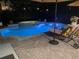Inviting backyard pool and spa with brick pavers and lounge chair, illuminated for evening enjoyment at 2540 Swoop Cir, Kissimmee, FL 34741