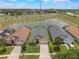 Aerial view of homes near the lake, showcasing well-maintained lawns and driveways at 2685 Oneida Loop, Kissimmee, FL 34747