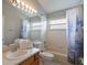 Bathroom features a combined shower and tub, single sink vanity, and a large mirror with vanity lighting at 2685 Oneida Loop, Kissimmee, FL 34747