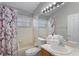 Bathroom features a combined shower and tub, toilet, single sink vanity, and a large mirror at 2685 Oneida Loop, Kissimmee, FL 34747