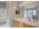 Bright main bathroom with dual sinks, lots of light, and access to the bedroom at 2685 Oneida Loop, Kissimmee, FL 34747