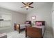 Cozy bedroom featuring twin beds with floral bedding, a ceiling fan, and tiled flooring at 2685 Oneida Loop, Kissimmee, FL 34747