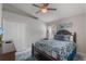 Bedroom features neutral walls, white trim, ceiling fan, and a large bed with patterned bedding at 2685 Oneida Loop, Kissimmee, FL 34747