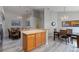 Dining area featuring wood flooring, stylish chandelier, and views of the kitchen and dining table at 2685 Oneida Loop, Kissimmee, FL 34747