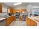 Well-lit kitchen with stainless steel appliances, breakfast bar, and plenty of cabinet space at 2685 Oneida Loop, Kissimmee, FL 34747