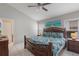 Well-lit main bedroom with a decorative wood frame bed and a view to the bathroom at 2685 Oneida Loop, Kissimmee, FL 34747