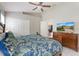 Bright and airy main bedroom featuring a television and access to the ensuite bathroom at 2685 Oneida Loop, Kissimmee, FL 34747