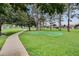 Community putting green beside a path and picnic area at 2685 Oneida Loop, Kissimmee, FL 34747