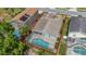Aerial view of the property showcases a screened-in pool and lush surroundings in a desirable community at 307 Balmoral Ct, Davenport, FL 33896