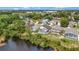 Aerial view of multiple single-Gathering homes and community, nestled against a tranquil lake at 307 Balmoral Ct, Davenport, FL 33896