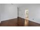 Spacious bedroom with hardwood floors and an open door to a bathroom at 307 Balmoral Ct, Davenport, FL 33896