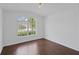 Bedroom features wood floors, large window, and ample natural light at 307 Balmoral Ct, Davenport, FL 33896
