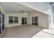Covered patio featuring ceiling fan, windows and sliding glass doors to bring the outdoors in at 307 Balmoral Ct, Davenport, FL 33896
