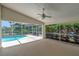 Enclosed patio with ceiling fan overlooking the pool and backyard at 307 Balmoral Ct, Davenport, FL 33896