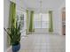 Bright dining area filled with natural light, accented by modern light fixture and decorative green drapes at 307 Balmoral Ct, Davenport, FL 33896