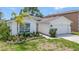Charming single-story home boasts well-manicured landscaping, an attached garage, and a welcoming front entrance at 307 Balmoral Ct, Davenport, FL 33896
