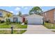 Inviting single-story home with a well manicured lawn and an attached two car garage at 307 Balmoral Ct, Davenport, FL 33896