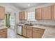 Functional kitchen with stainless steel appliances, light wood cabinets, and bright natural light at 307 Balmoral Ct, Davenport, FL 33896