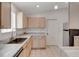 Well-lit kitchen featuring stainless steel appliances, light wood cabinetry, and marble countertops at 307 Balmoral Ct, Davenport, FL 33896
