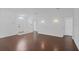 Bright living room featuring hardwood floors, neutral walls, and a classic entryway with arched window at 307 Balmoral Ct, Davenport, FL 33896