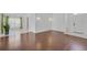 Inviting living room with hardwood floors, light-filled windows, and an open floor plan to adjacent dining space at 307 Balmoral Ct, Davenport, FL 33896