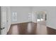 Well-lit living area featuring neutral walls, sliding glass doors to lanai, and hardwood floors for a clean look at 307 Balmoral Ct, Davenport, FL 33896