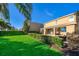 Beautifully landscaped backyard with well-manicured lawn, hedges, and a relaxing patio area at 321 Lasso Dr, Kissimmee, FL 34747