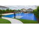 Outdoor basketball court with vibrant blue surface and neatly manicured artificial grass surroundings at 321 Lasso Dr, Kissimmee, FL 34747