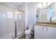 A bright bathroom with a walk-in shower, granite countertop, and sleek white cabinetry at 321 Lasso Dr, Kissimmee, FL 34747
