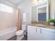 Well-lit bathroom with shower-tub combo, granite countertop, and a large window at 321 Lasso Dr, Kissimmee, FL 34747