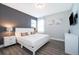 Inviting bedroom with dark accent wall, TV, luxury vinyl flooring, and soft, natural light at 321 Lasso Dr, Kissimmee, FL 34747