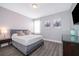 Comfortable bedroom with gray walls, TV, luxury vinyl flooring, and soft, natural light at 321 Lasso Dr, Kissimmee, FL 34747