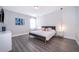 Modern bedroom with a striking blue bed frame, luxury vinyl flooring, and soft, natural light at 321 Lasso Dr, Kissimmee, FL 34747